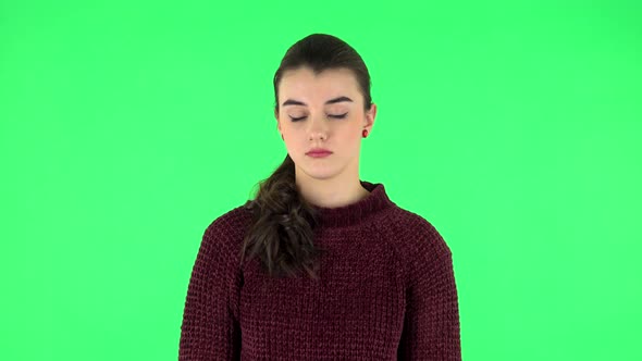 Girl Listens Carefully To Boring Information and Looks Around. Green Screen