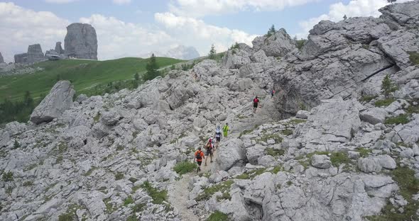 Aerial drone view of a group of people hiking in the mountains