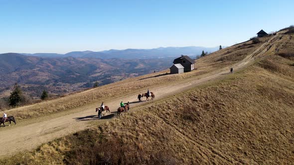 Aerial View People Riding Horse Attraction at the Top of Mountain