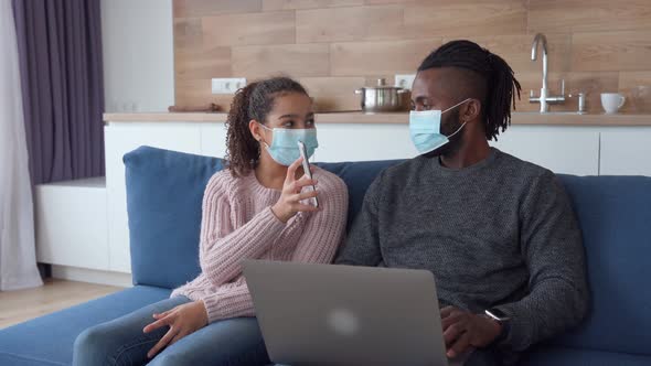 Lifestyle Portrait of Afro American Family Sitting at Home in Protective Masks