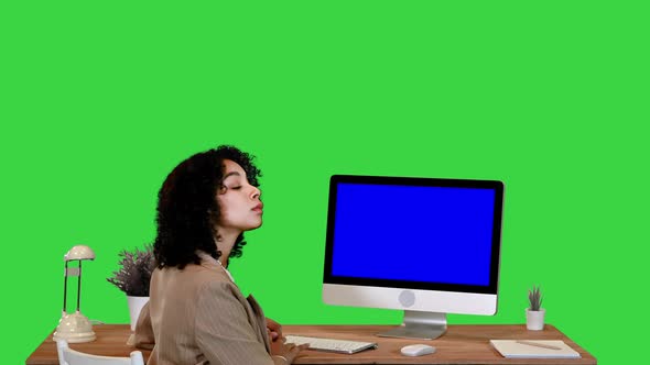 African Girl at a Blank Monitor Screen Smiling To Camera Mockup Display on a Green Screen Chroma Key