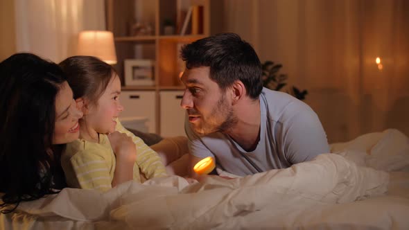 Happy Family with Torch Light in Bed at Home 19