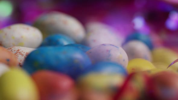 Rotating shot of colorful Easter candies on a bed of easter grass 