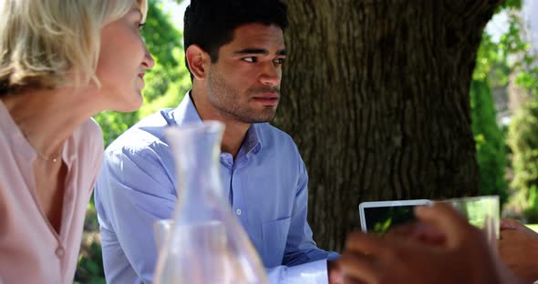 Friends interacting with each other at restaurant