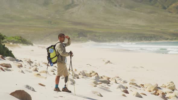 Sporty mixed race man with prosthetic leg hiking