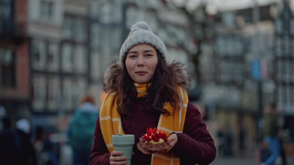 Portrait of Young Woman Enjoying Beautiful Desert with Coffee on a Street of European Town