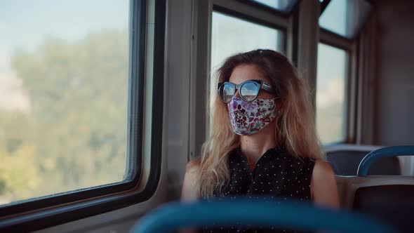Girl In Face Mask Protection Epidemic Coronavirus On Public Transport. Female In Face Mask On Tram.