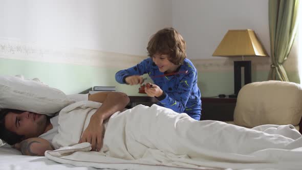 Older Brother Sleep in Bed and Younger Brother Wake Him Up While Playing the Violin