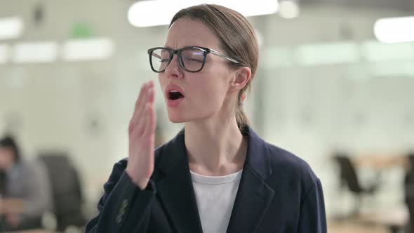 Portrait of Sleepy Young Businesswoman Yawning