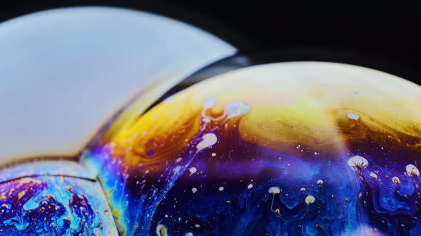 Macro Shot of a Soap Bubble Creates a Colorful and Black Background