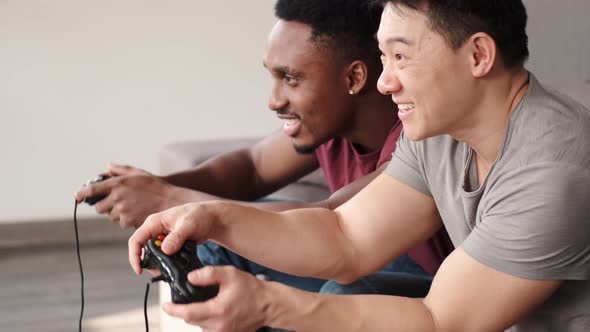 Excited Friends Playing Video Games at Home