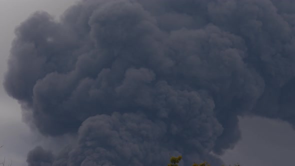 Thick black smoke covers the sky during the war between Ukraine and Russia