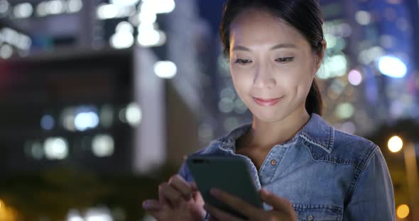 Young woman use of mobile phone in city