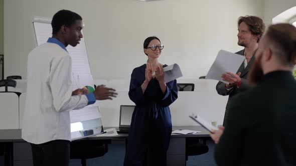 Successful Positive Business Team Clapping Smiling Standing in Office Board Room Indoors