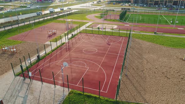 Empty Basketball Ground with Fence on Area of Sports Center