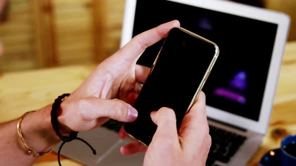 Male customer using mobile phone at counter