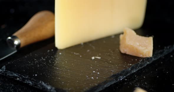 Pieces of Parmesan Cheese Falling on the Table