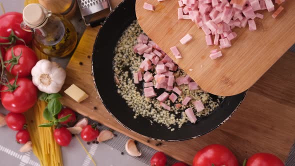 Making Pasta Carbonara  Pouring Chopped Pancetta Bacon Into Frying Pan