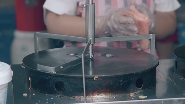 Water Drops Boil on Metal Pancake Maker in Cafe Kitchen