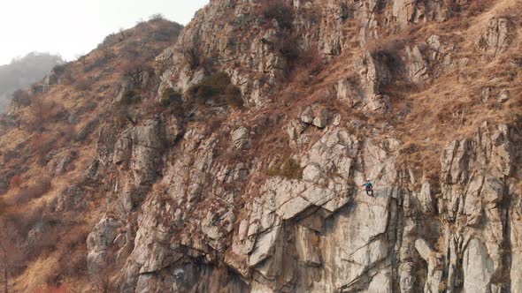 Man Athlette Climbing on the High Rock