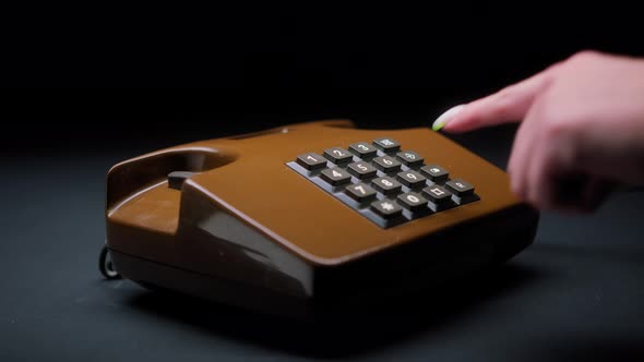 Female Hand Holding Old and Retro Brown Telephone Headset Isolated on Black Background Woman Hands