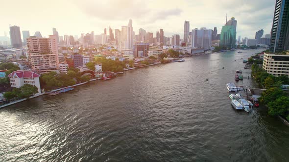 4K : Drones fly over the Chao Phraya River, buildings and business districts