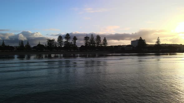 Waves rolling in at golden hour in Orewa