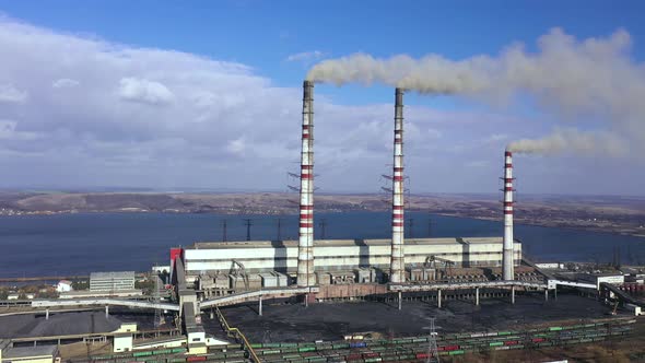 Aerial View of Old Thermoelectric Plant with Big Chimneys in a Rural Landscape Near the Reservoir