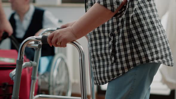 Close Up of Senior Patient with Disability Using Walk Frame