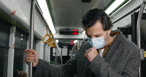 Crop View of Man in Medical Mask Having Cough and Looking Ill in Tram