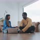Young couple sitting on the floor of new home disagreeing - VideoHive Item for Sale
