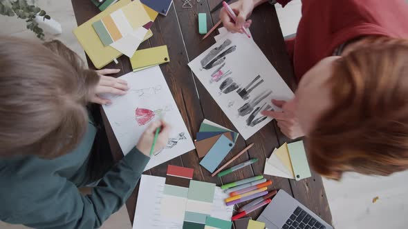 Timelapse of Two Designers Drawing Fashion Sketches with Color Pencils