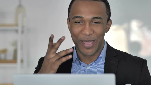 Close Up of Online Video Chat By Casual AfroAmerican Businessman at Work