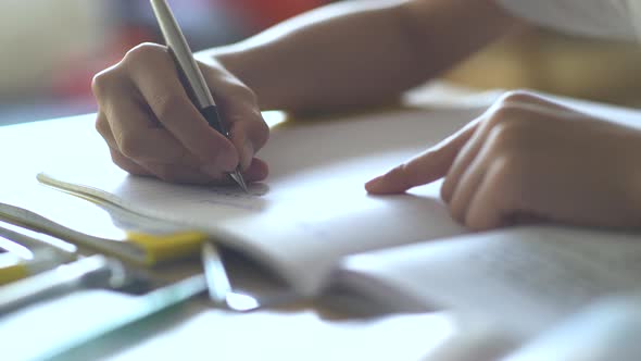 Boy writing on book