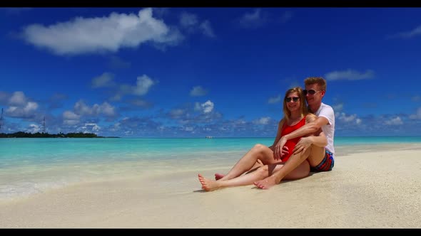 Man and lady sunbathe on marine tourist beach wildlife by blue ocean and white sandy background of t