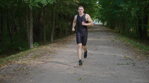 Morning Jog Man Runner on a the Road Athlete Trains in an Nature Environment Triathlon Competitions