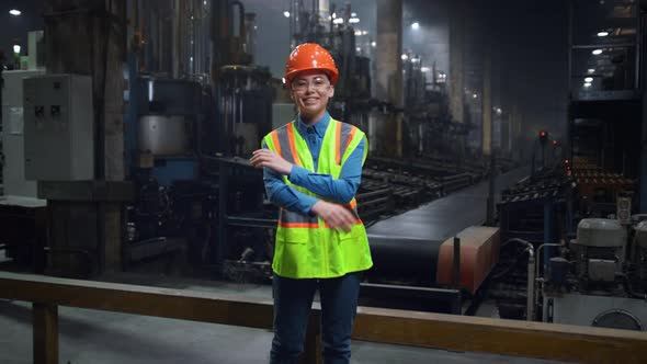 Woman Mechanic Crossing Hands Looking Camera at Manufacturing Special Facility