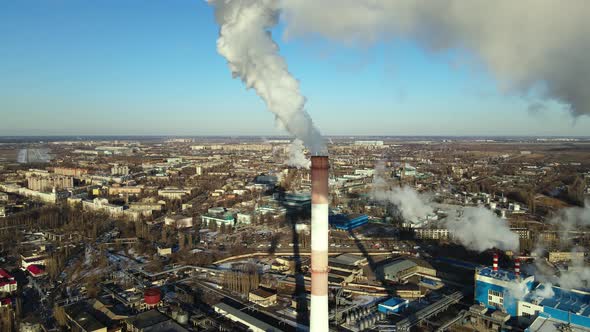 Industrial emissions of smoke from factory pipes in indistrial zone