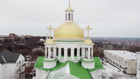 Orthodox Church with Golden Domes in a Cloudy Winter Day