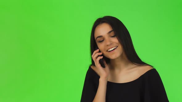 Attractive Young Woman in Black Dress Talking on the Phone