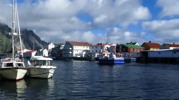Fishing boat passing by at the village Henningsvaer