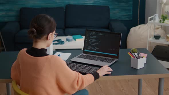 Young Woman Programming Binary Code on Laptop Screen