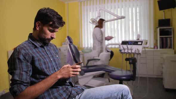 Client Using Phone Waiting Dentist's Appointment