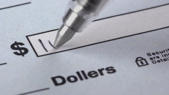 Close up shot of someone filling out a check