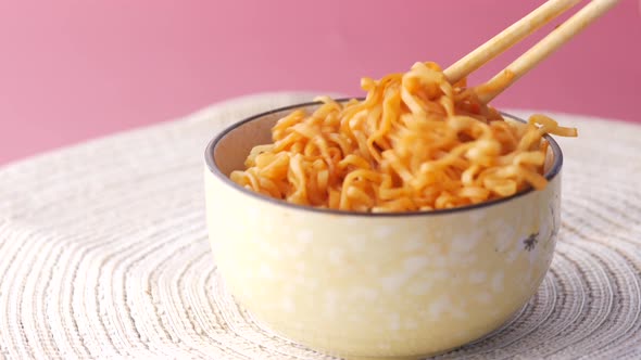Noodles with Chopsticks on Red Background