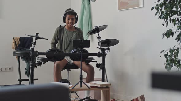 Girl Talking and Playing E-drums on Camera