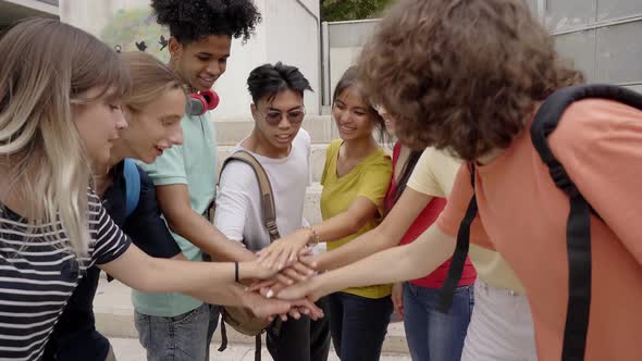 Group of Teenage Friends Highfiving Each Other Happy and Motivated Having a Good Time Together