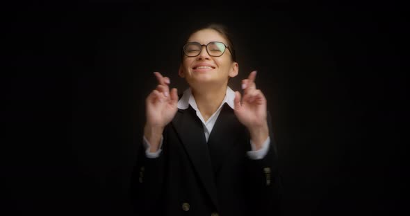 Hopeful Asian Business Woman Keeping Fingers Crossed Isolated Black Background