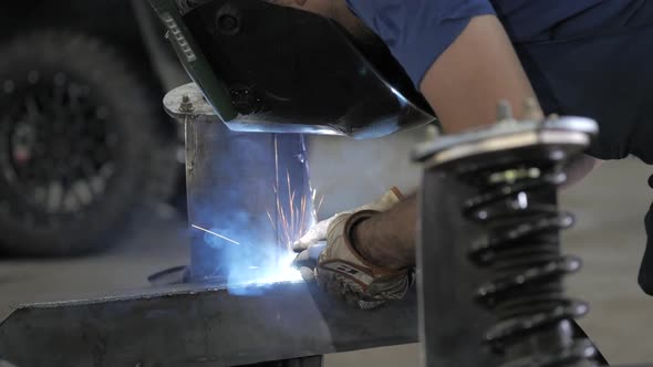 Welding Process. Welder In Helmet Works, Worker Works In The Auto Workshop