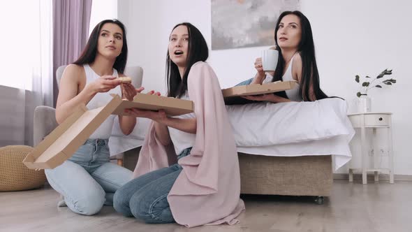 The Pretty Ladies Are Eating a Takeaway Pizza in Bedroom and Smiling